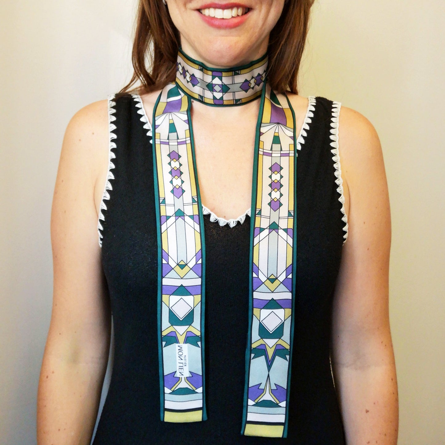 striscia di seta annodata intorno al collo in modo elegante con losanga rettangoli e righe